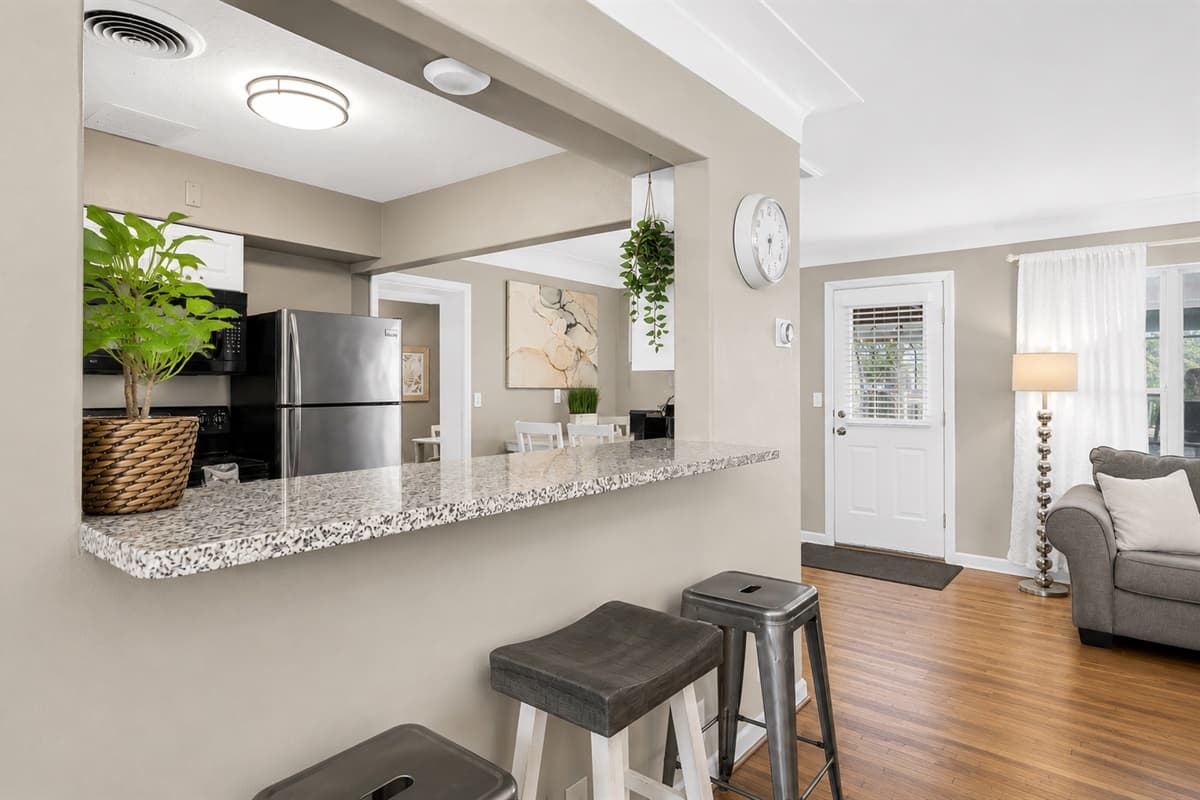 Cozy breakfast bar seating area connecting the kitchen and living room spaces.