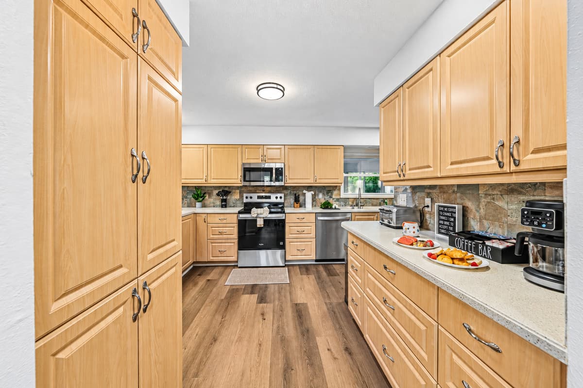 Spacious kitchen with ample cabinetry and prep space, ideal for cooking for large groups 