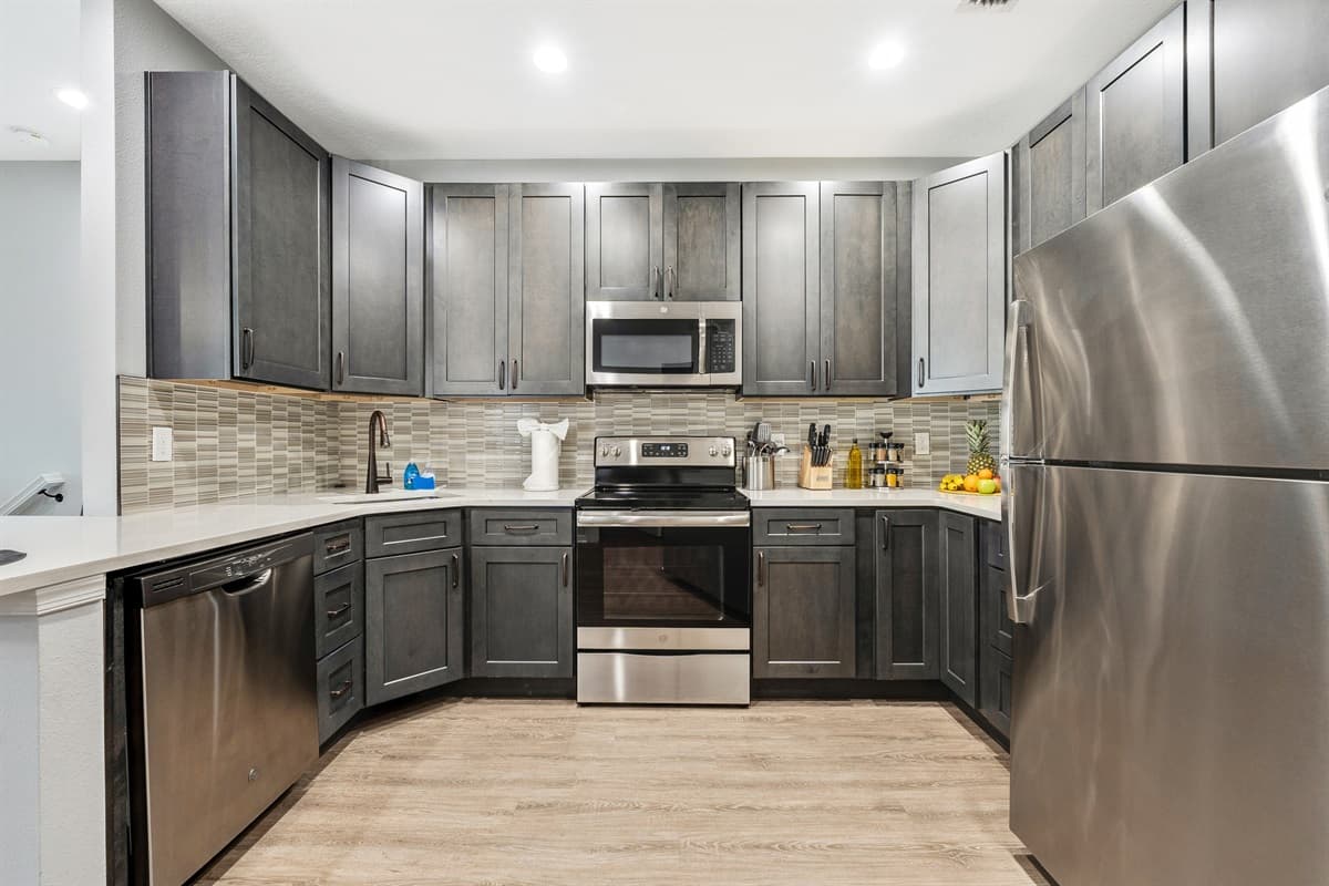 Natural light floods the space through strategically placed windows, creating a bright and inviting atmosphere that adds to the overall warmth of the kitchen.