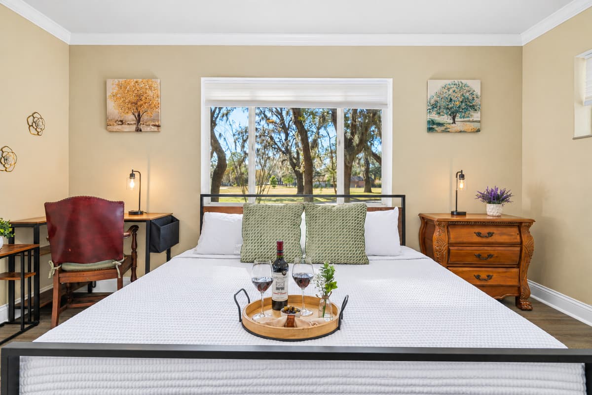 The king-size bed anchors this inviting bedroom, offering plush comfort and a tranquil retreat after a full day.