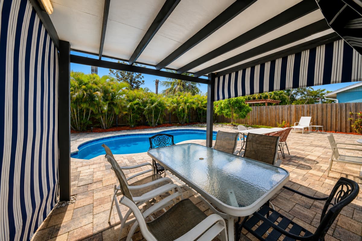 Covered outdoor space perfect for morning coffee, family meals, and evening gatherings.