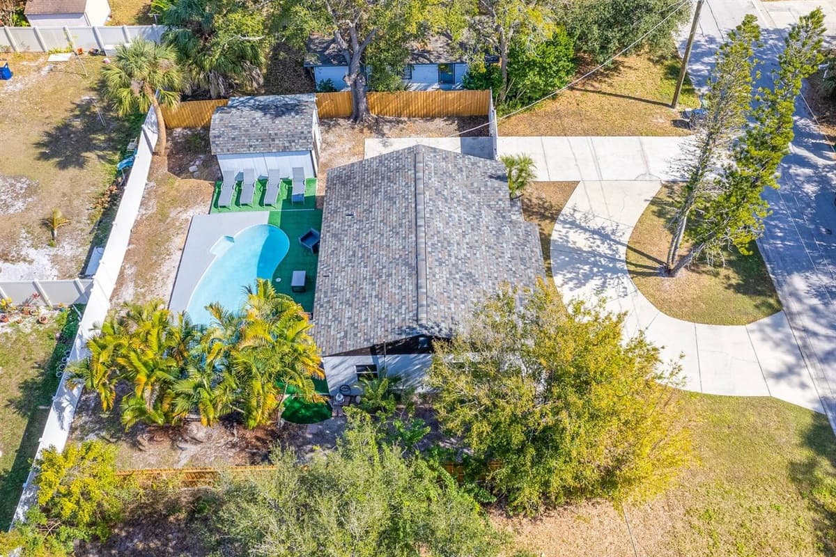 Aerial side view of this lovely property! Worry not about kids playing in the fully fenced backyard during your stay! Inquire about this property now!
