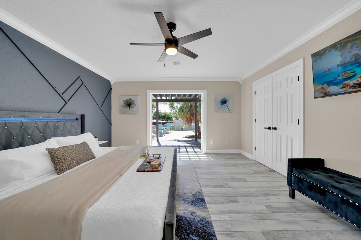 A tufted tan headboard and soft neutral tones make this second king suite feel like its own private getaway