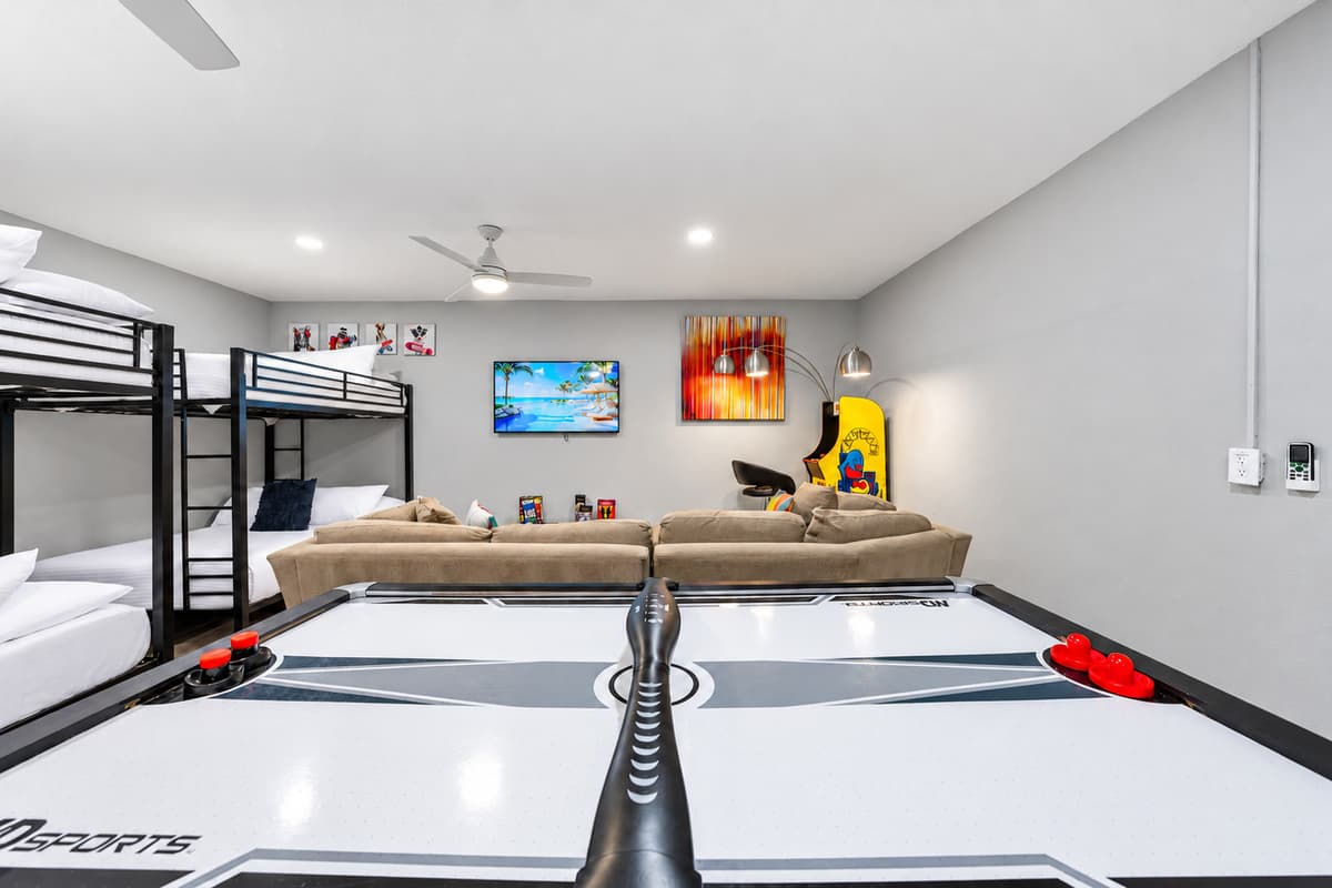 Spacious recreation room with bunk beds, games, and entertainment for guests of all ages.
