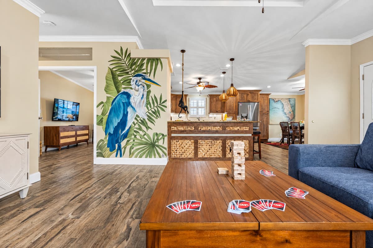 A bright, open living area with plantation shutters and warm wood floors offers the ideal environment for both lounging and entertaining.