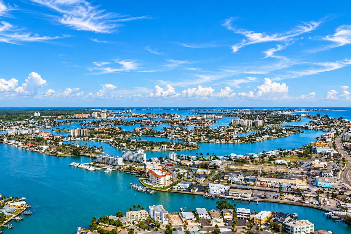 Panoramic aerial view of the surrounding waterways, marinas, and coastal neighborhood.