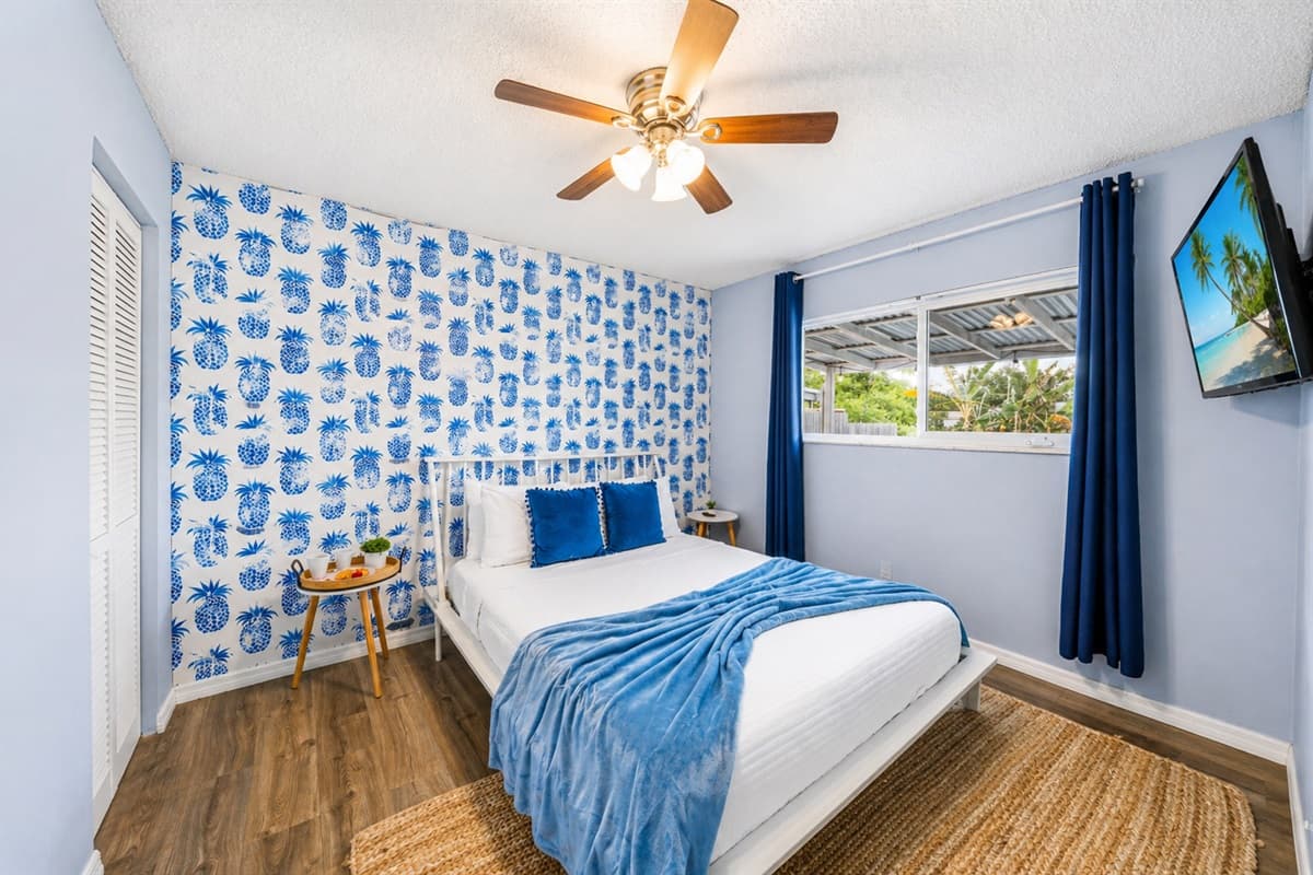 Bright Bedroom 3 featuring a comfortable king bed, bold coastal accents, and natural light.