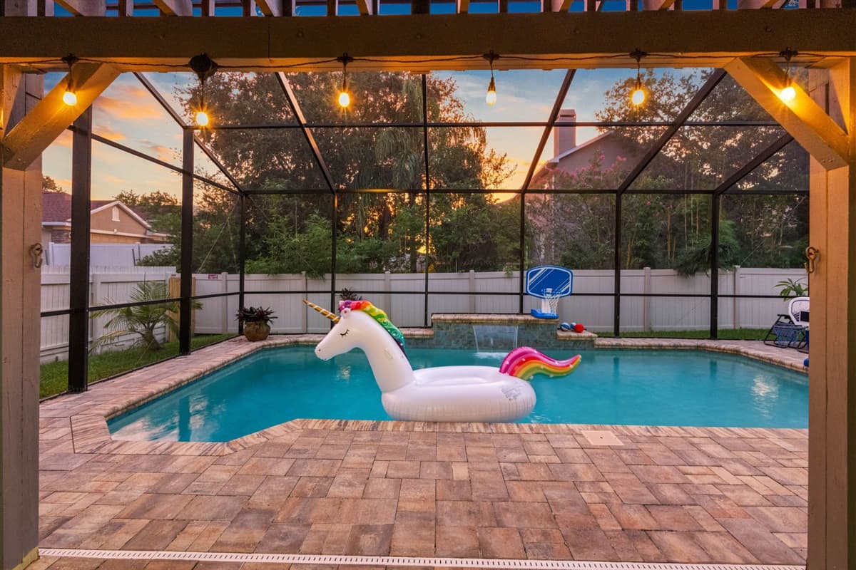 Surrounded by cozy seating, string lights, and a fully fenced yard, this pool becomes the ultimate backdrop for relaxation and celebration.