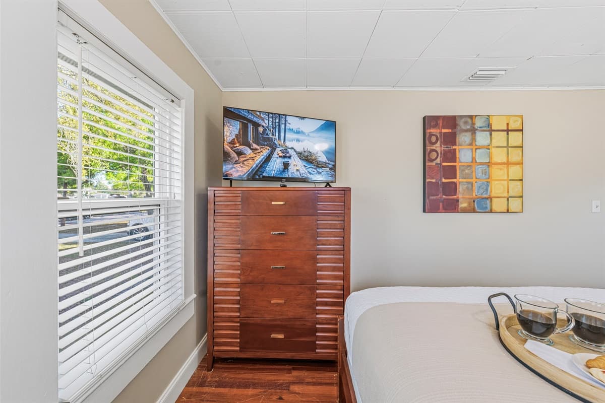 Bedroom with dresser and TV, perfect for unwinding after a long day.