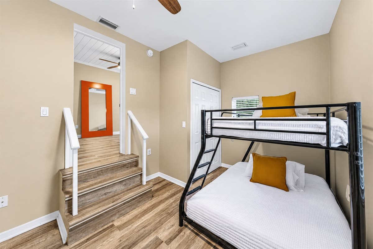 Bunk room with comfortable beds and nearby stair access—great for families or group stays.