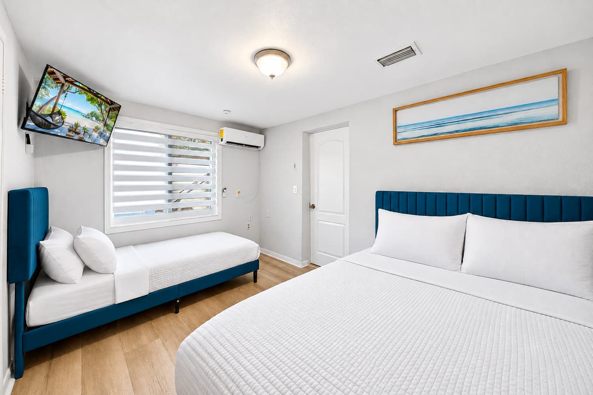 Large primary suite featuring a king bed, cozy daybed seating area, Smart TV, and plenty of room to relax and unwind.