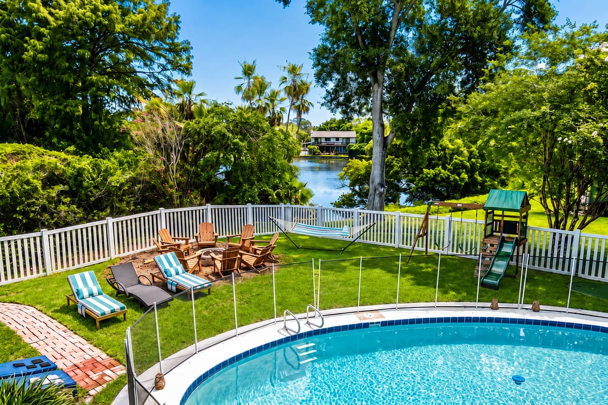 Fenced pool, loungers on the deck, fire pit past the gate, playground at the end. Nothing is far from anything.