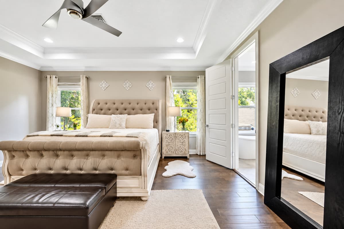 Large windows allow natural light to fill the room during the day, providing a cheerful and airy feel.