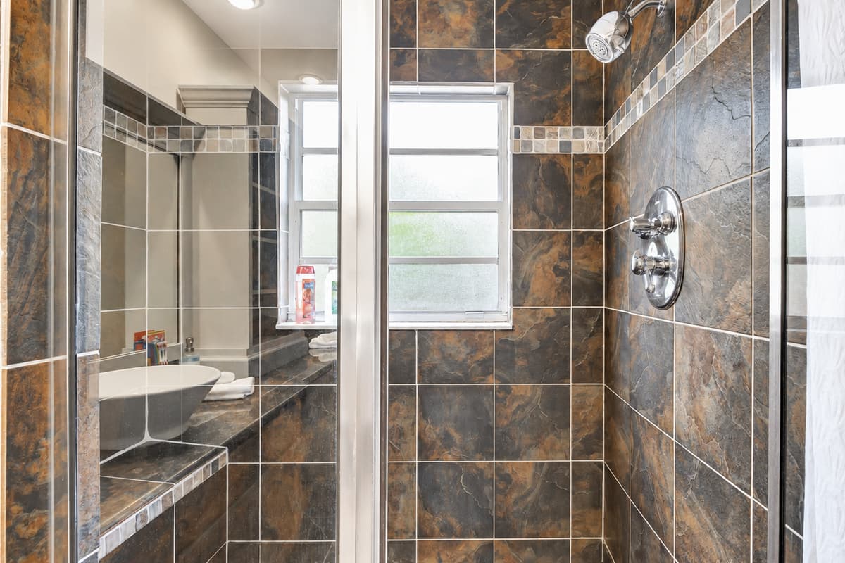 Unleash the power of functionality with a sleek toilet and indulge in the luxury of a spacious walk-in shower.