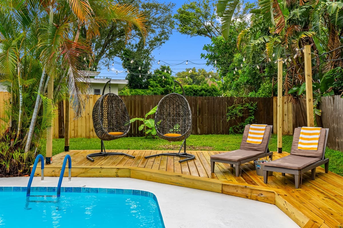 A backyard that feels like a resort—with flamingo floats, tiki vibes, and sunshine for days.