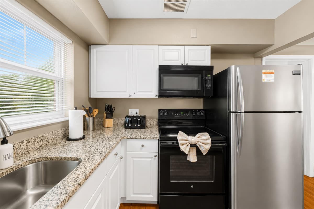 Cozy kitchen area with modern appliances, ample cabinetry, and bright natural lighting.