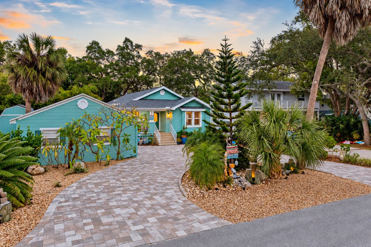 A well-kept front porch and tropical landscaping complement the home’s stylish modern-coastal finish.