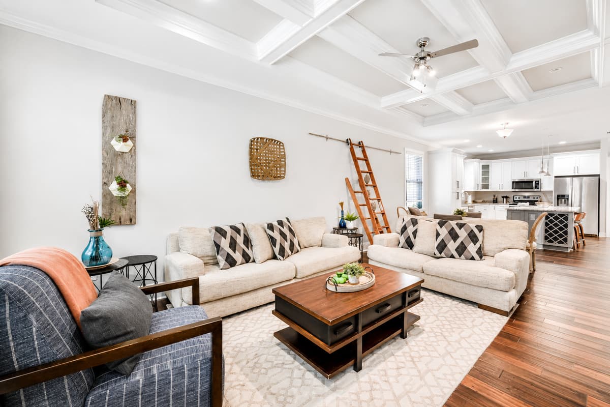 The open living room offers plenty of seating, making it ideal for family movie nights or spending time together.