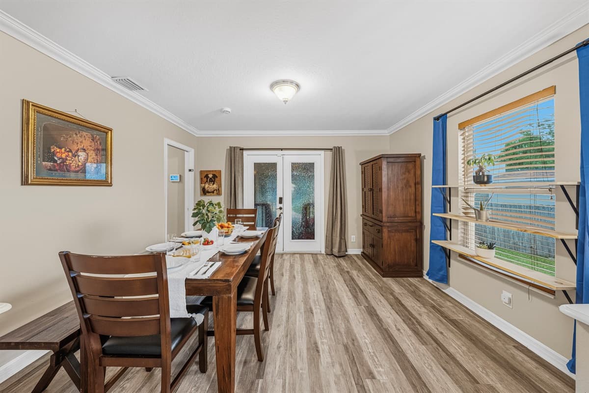 Bright dining room with natural light and backyard views—perfect for relaxed dining experiences.