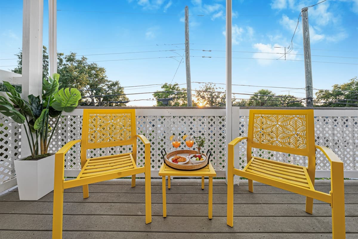 Close-up of outdoor seating setup with decorative touches for a relaxing vibe 
Food and drinks shown are for staging purposes only and are not included.