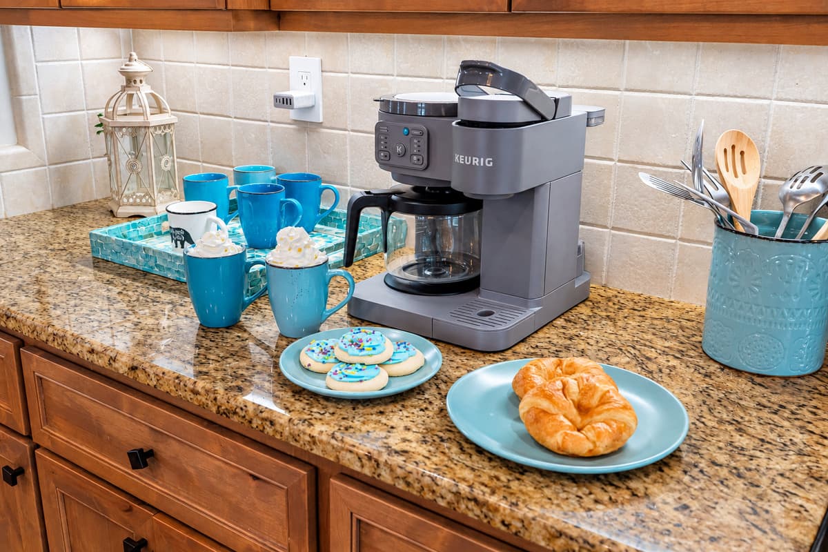 Enjoy morning coffee at the beautifully crafted island while natural light fills the room through plantation-shuttered windows.