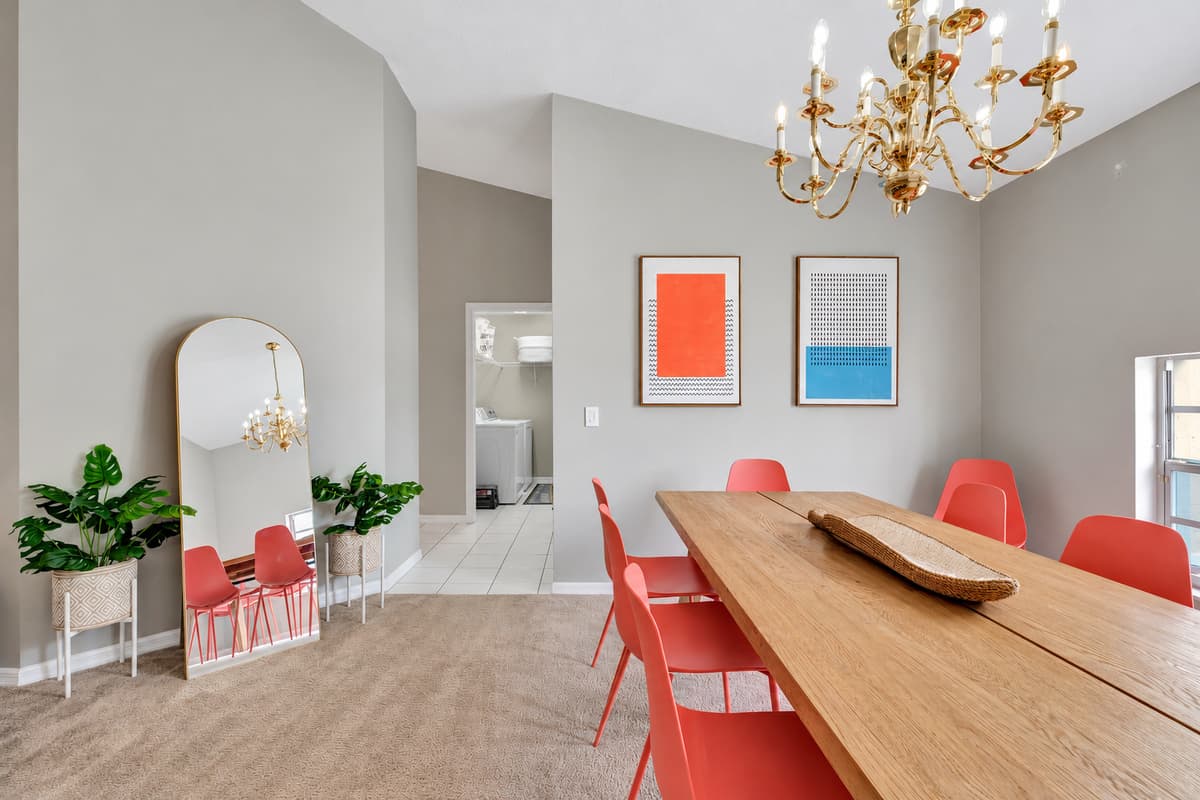 At the center of it all stands a magnificent wooden dining table, adorned with eight chairs, inviting you to gather and indulge in culinary delights.