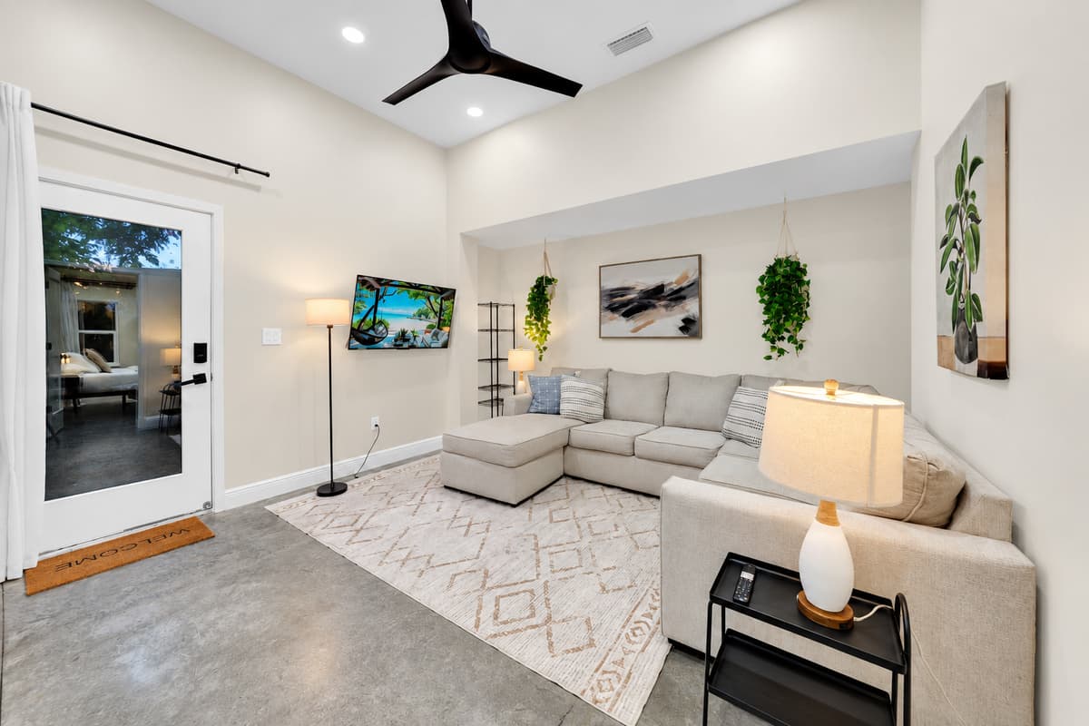 A whole second living room, whenever you need it. Deep sectional, smart TV and vaulted ceilings, so the movie crowd and the early sleepers stop competing for the same space every evening.