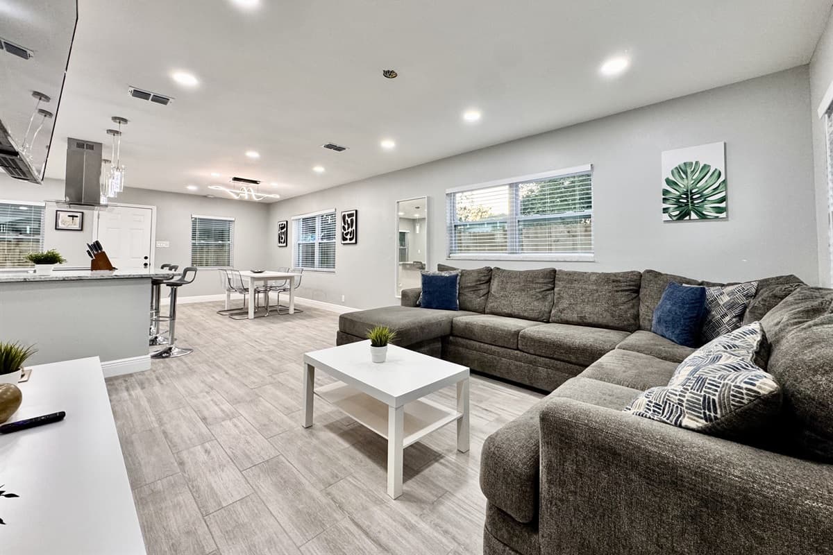At the center of the living area is a plush and generously sized sofa, designed to comfortably seat your entire group.