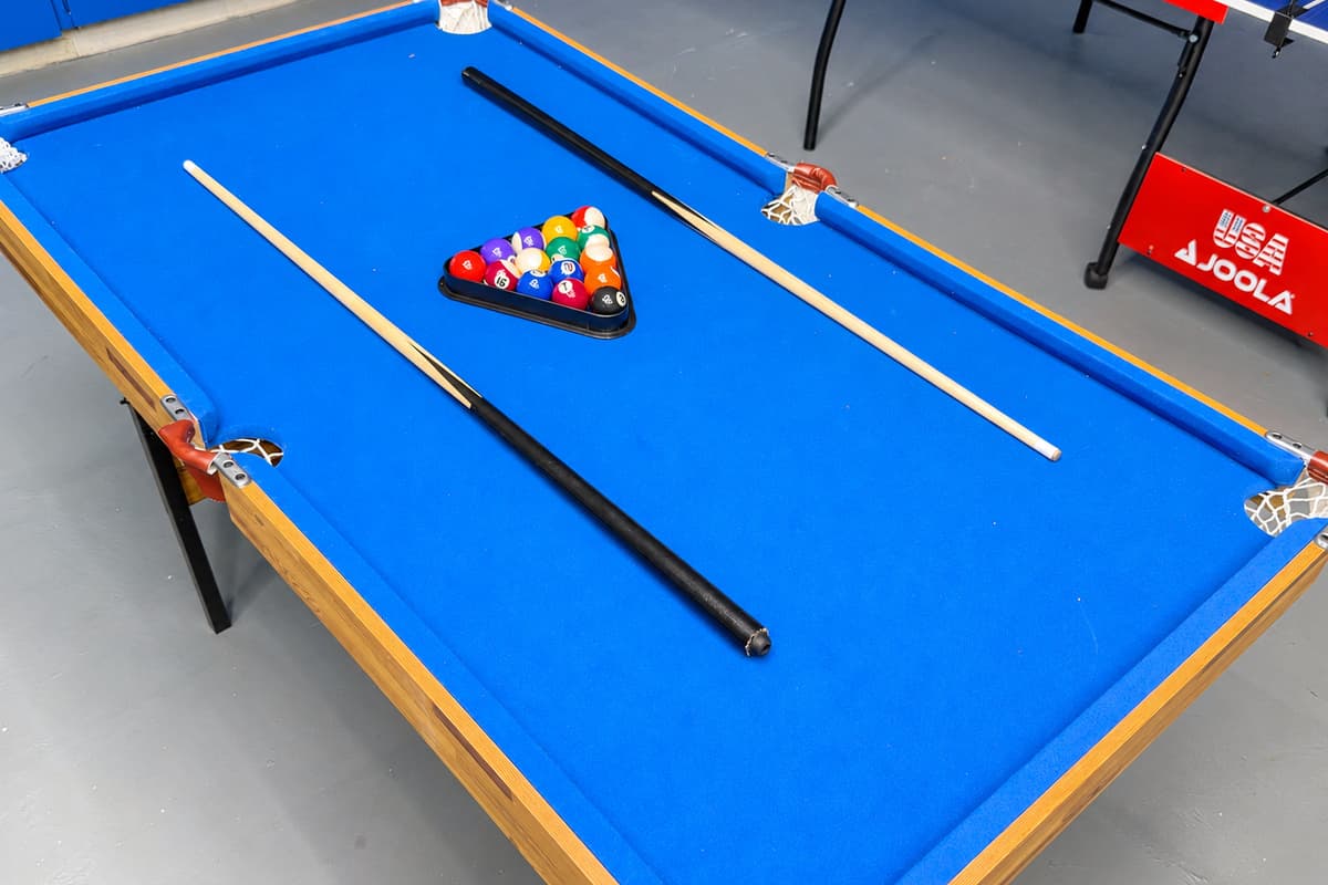 A modern, well-equipped game room featuring stylish lighting and entertainment for everyone to enjoy.