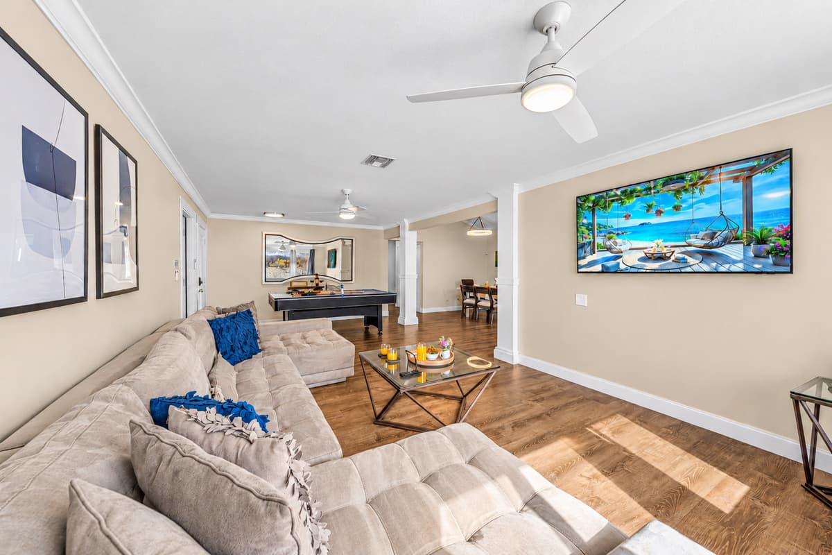 Open-concept living area featuring comfortable seating, a Smart TV, and plenty of natural light.