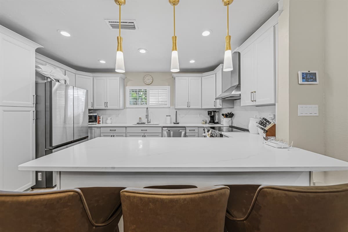 Large breakfast bar seating area perfect for casual dining, morning coffee, or entertaining guests.