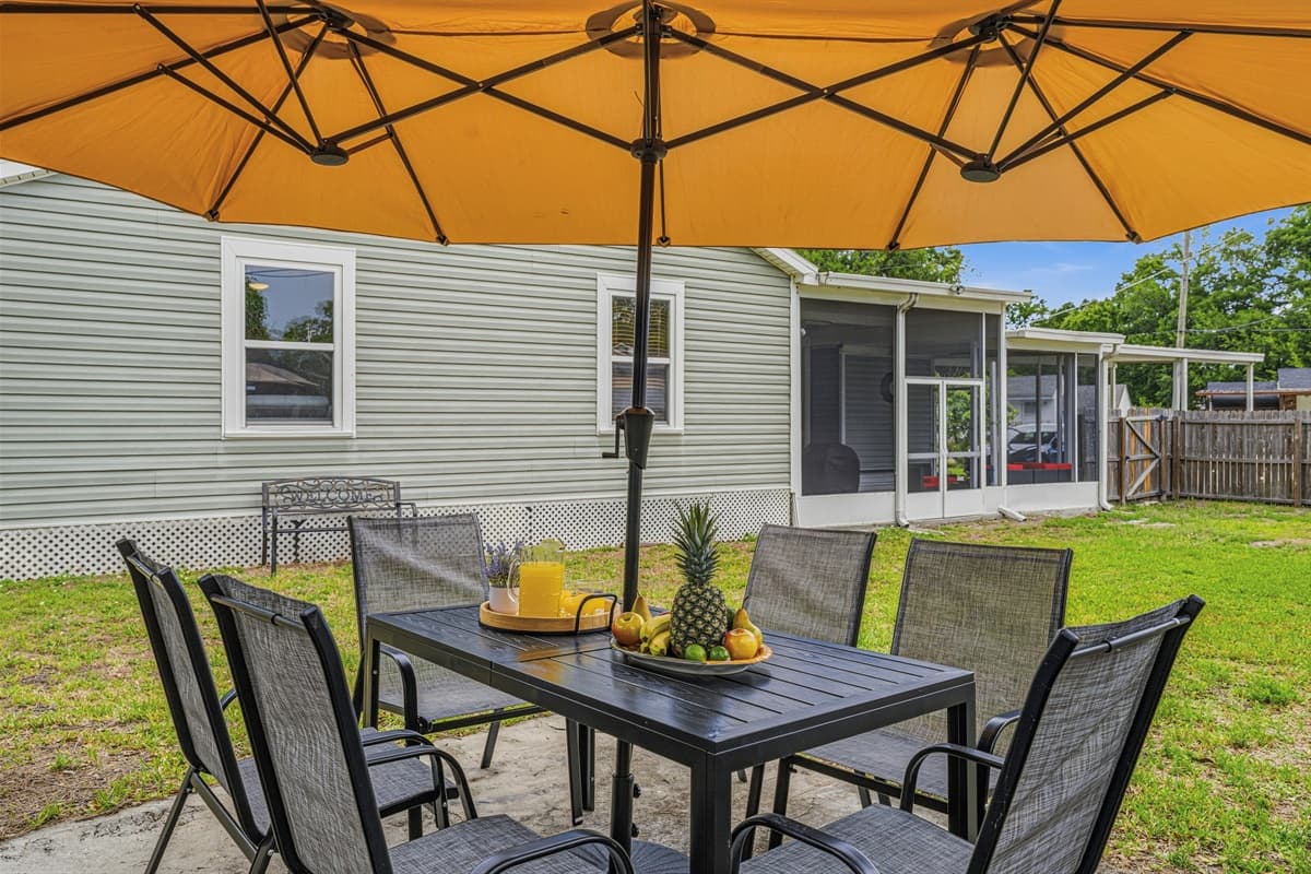 Backyard patio dining area with umbrella shade—perfect for outdoor meals.