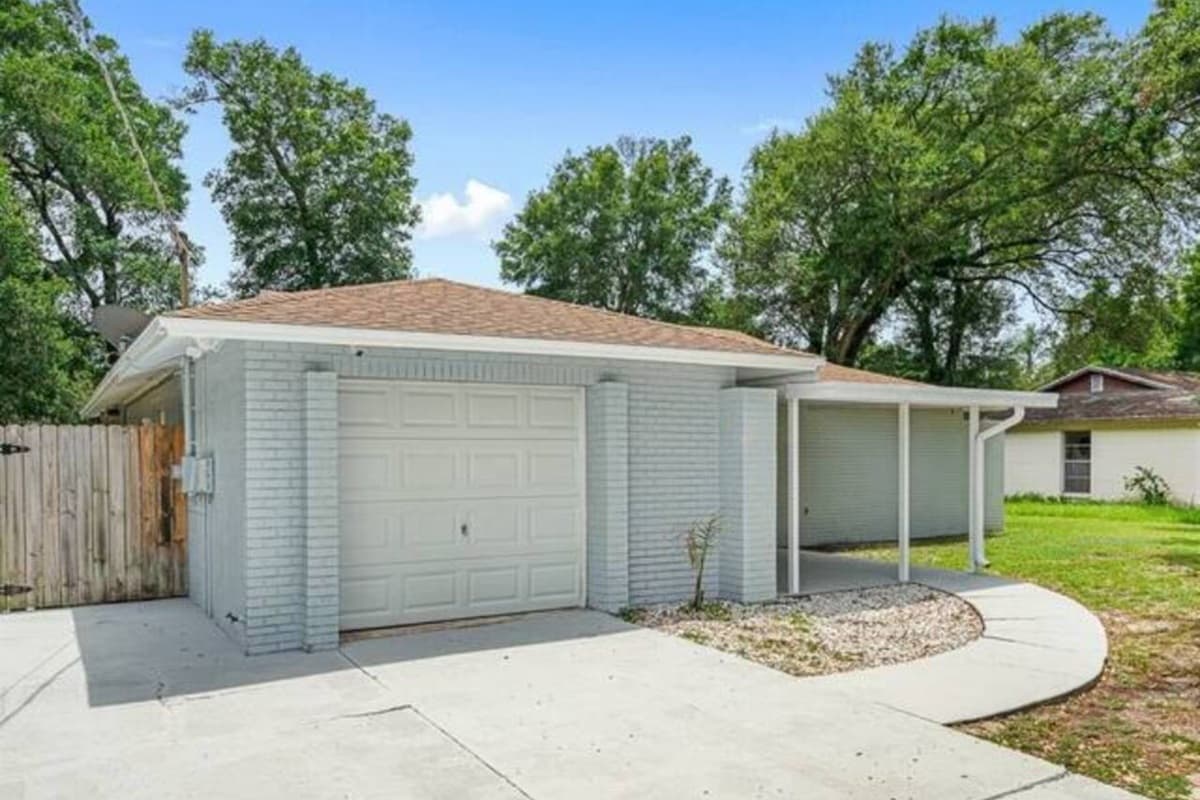The beautiful front of the house showcasing our magnificent front yard, amazing trees, and driveway. If you are interested in this property, don't hesitate to send us a message! Book now!