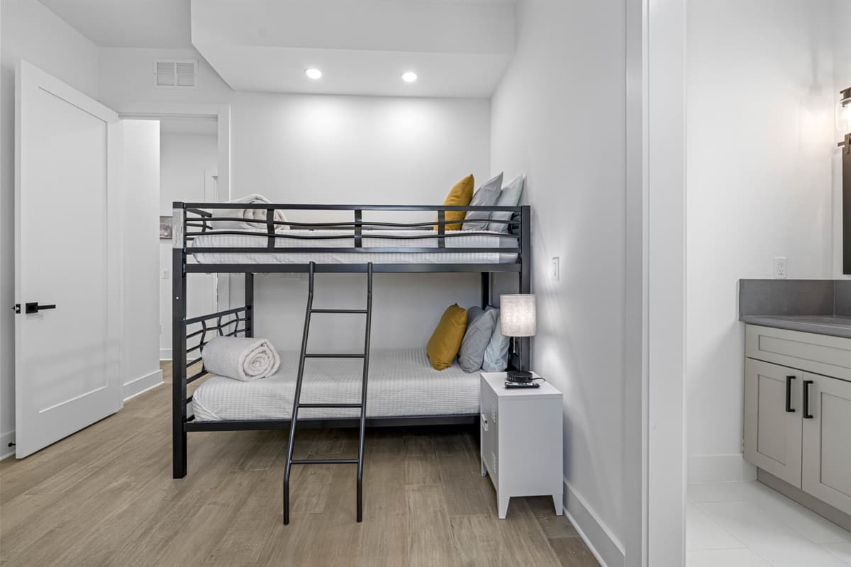 This bedroom features a stylish bunk bed and a private ensuite bathroom, this room offers a perfect blend of practicality and relaxation.