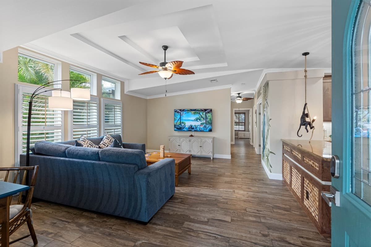 This open and airy living room features bright natural light, comfortable seating, and seamless access to the home's common areas.