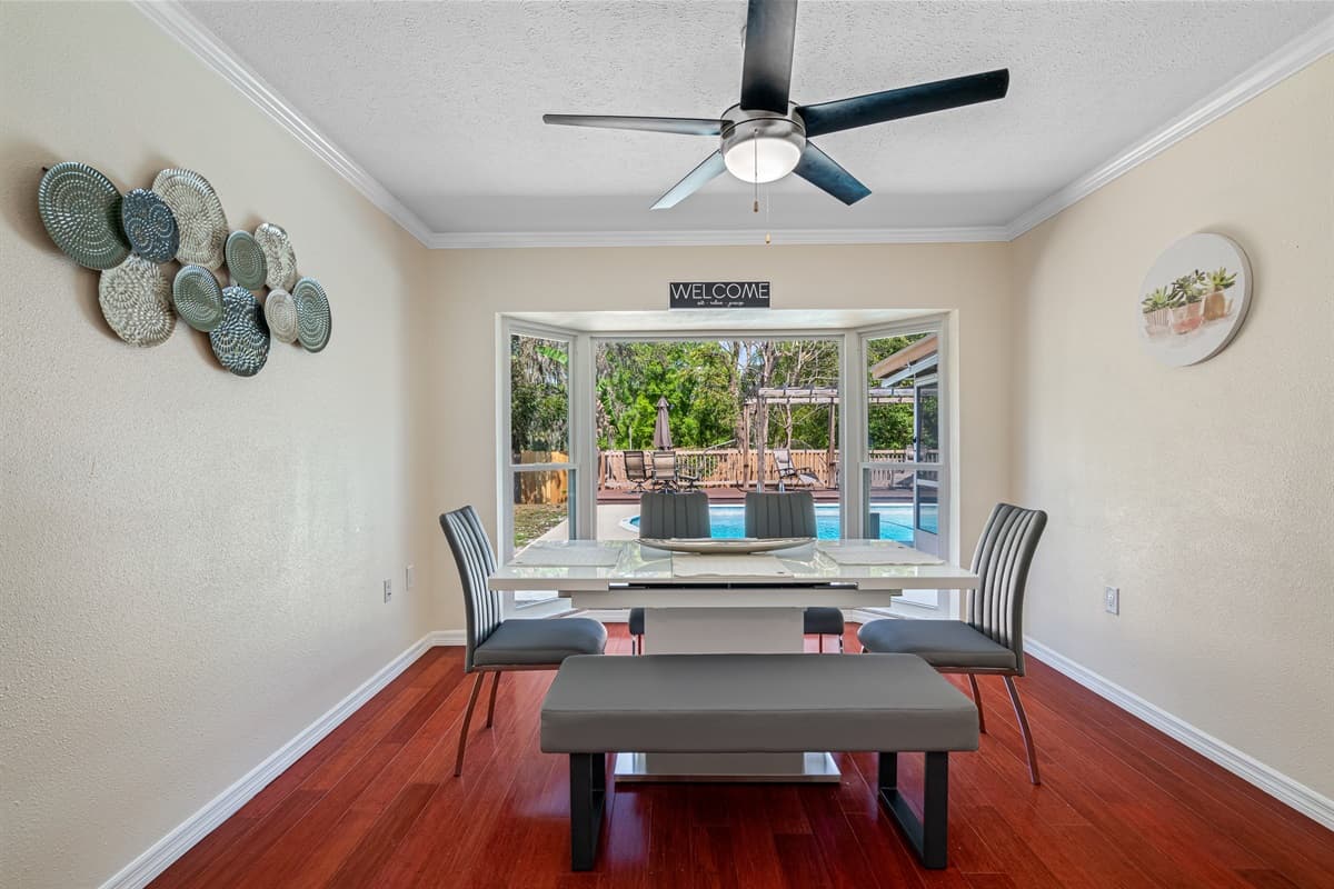 The sleek and minimalist dining table, surrounded by comfortable chairs, invites you to gather around and indulge in a delicious meal with your loved ones.