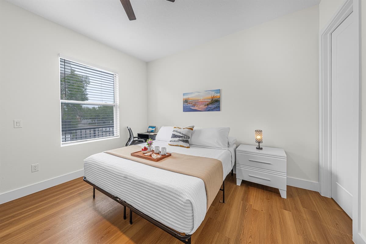 Cozy bedroom with comfortable bed, natural light, and clean, modern design.