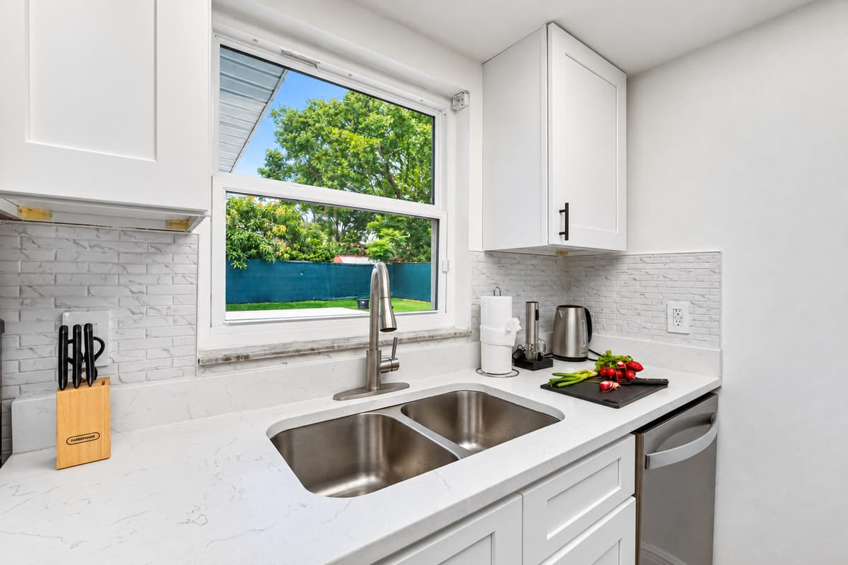 Thoughtful touches like soft-close drawers and under-cabinet lighting elevate the cooking experience.