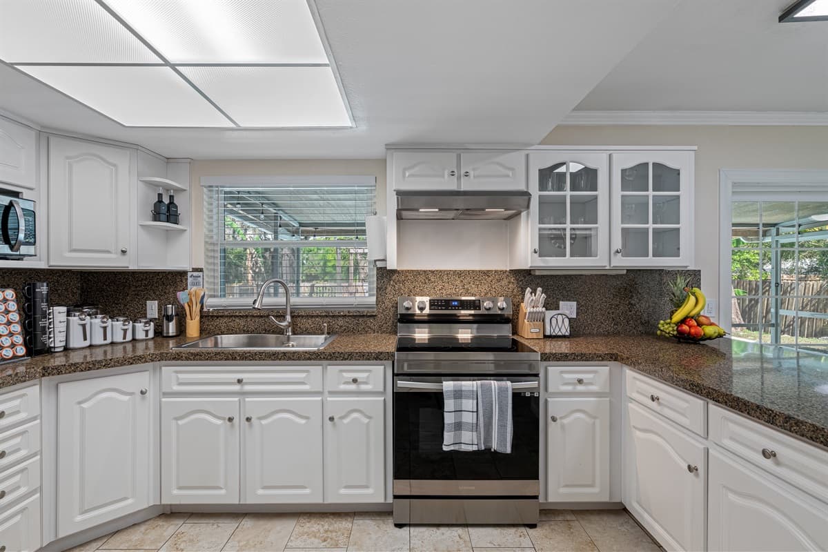 From the rich, warm tones of the cabinets to the gleaming stainless steel finishes, this kitchen is both stylish and functional.