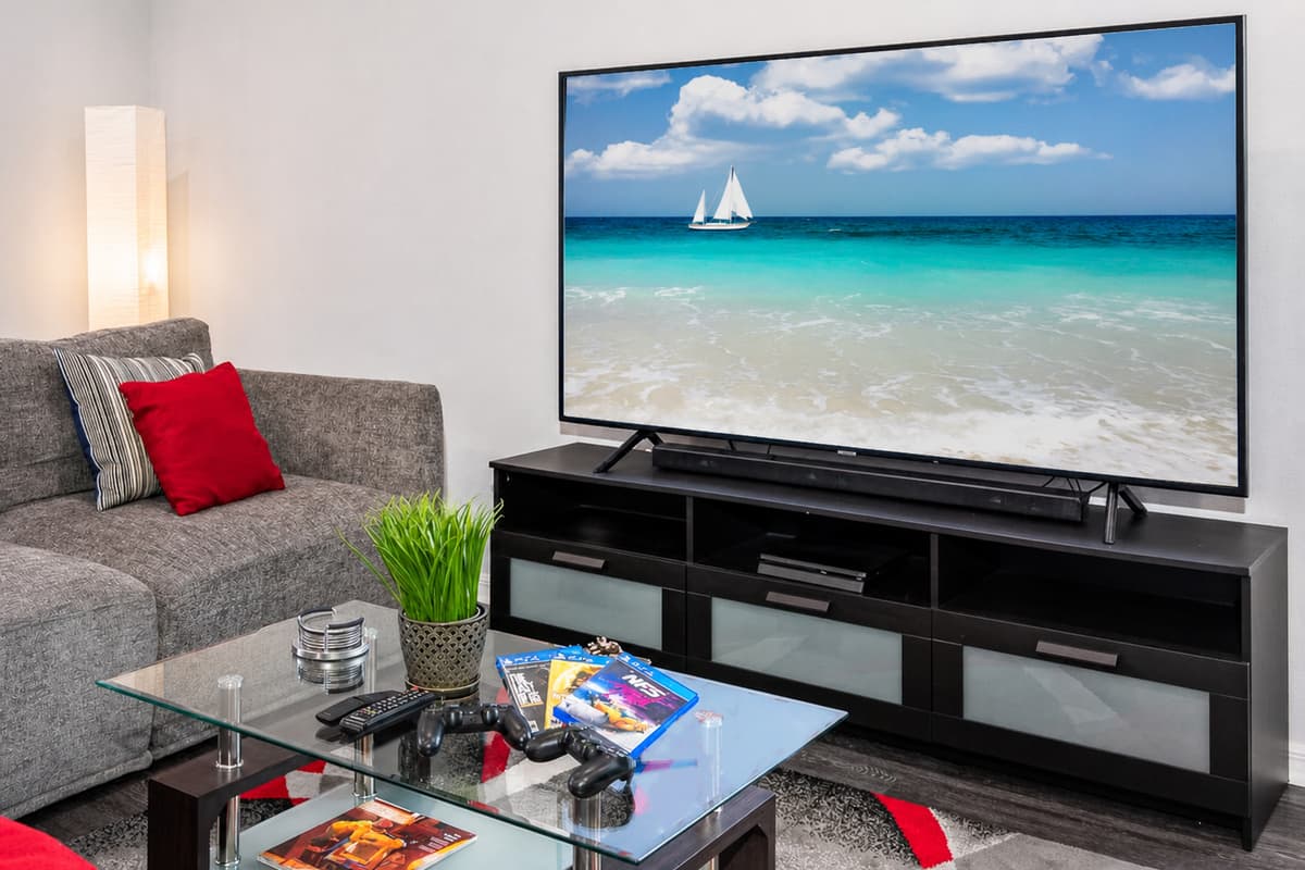 Adjacent to the couch, a smart TV takes center stage, offering a world of entertainment at your fingertips.