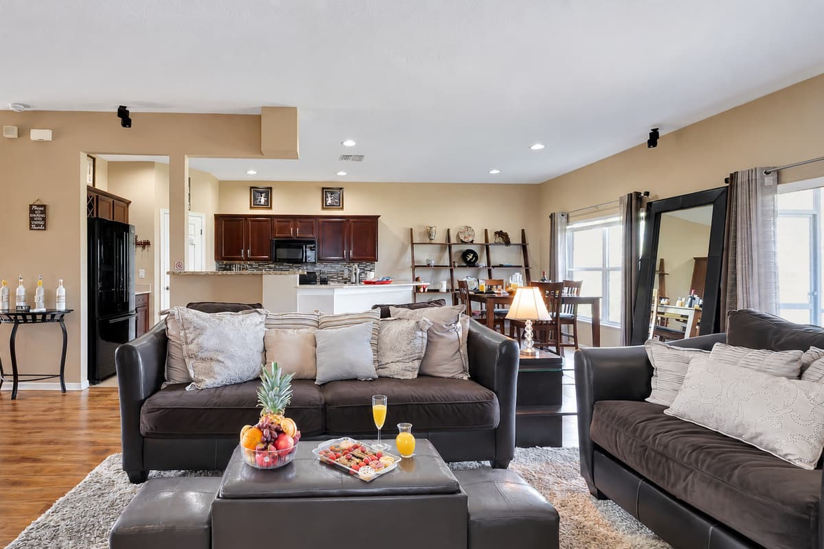Our spacious living room beckons with a massive, plush grey sofa that practically envelops you in relaxation.