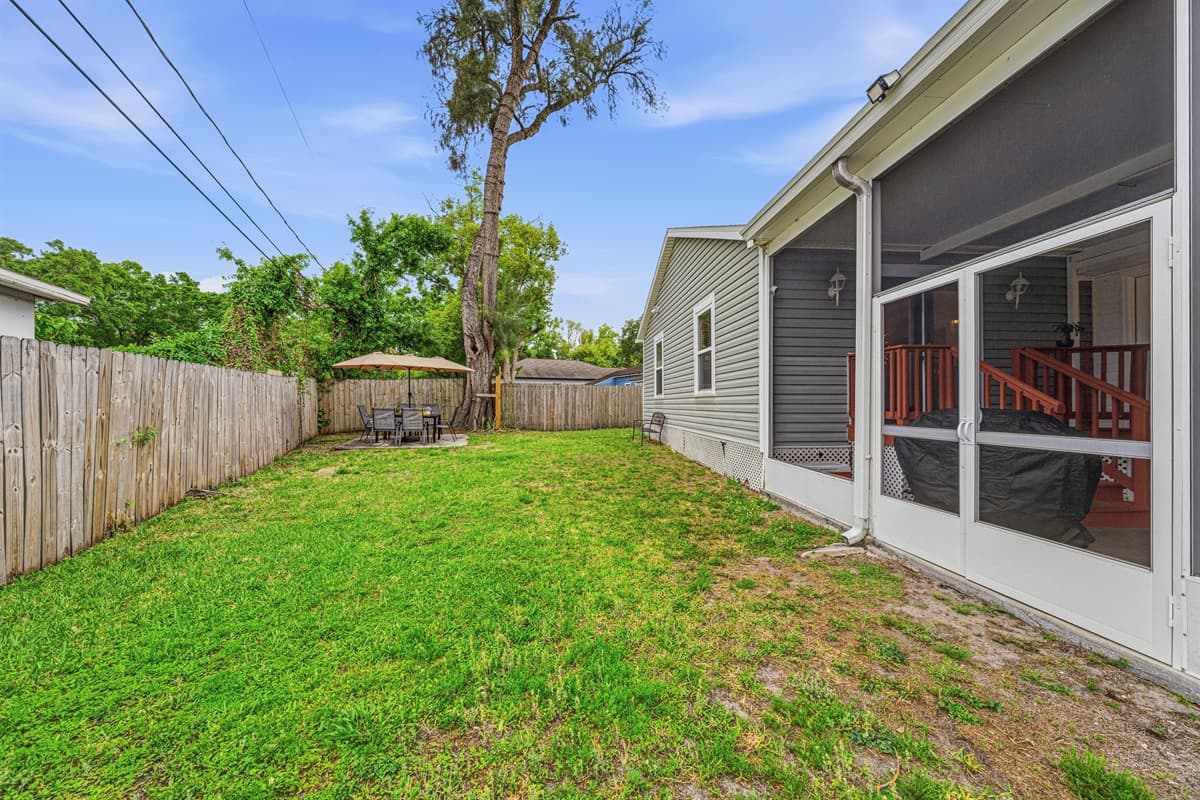 Spacious fenced backyard with plenty of room to relax or play.