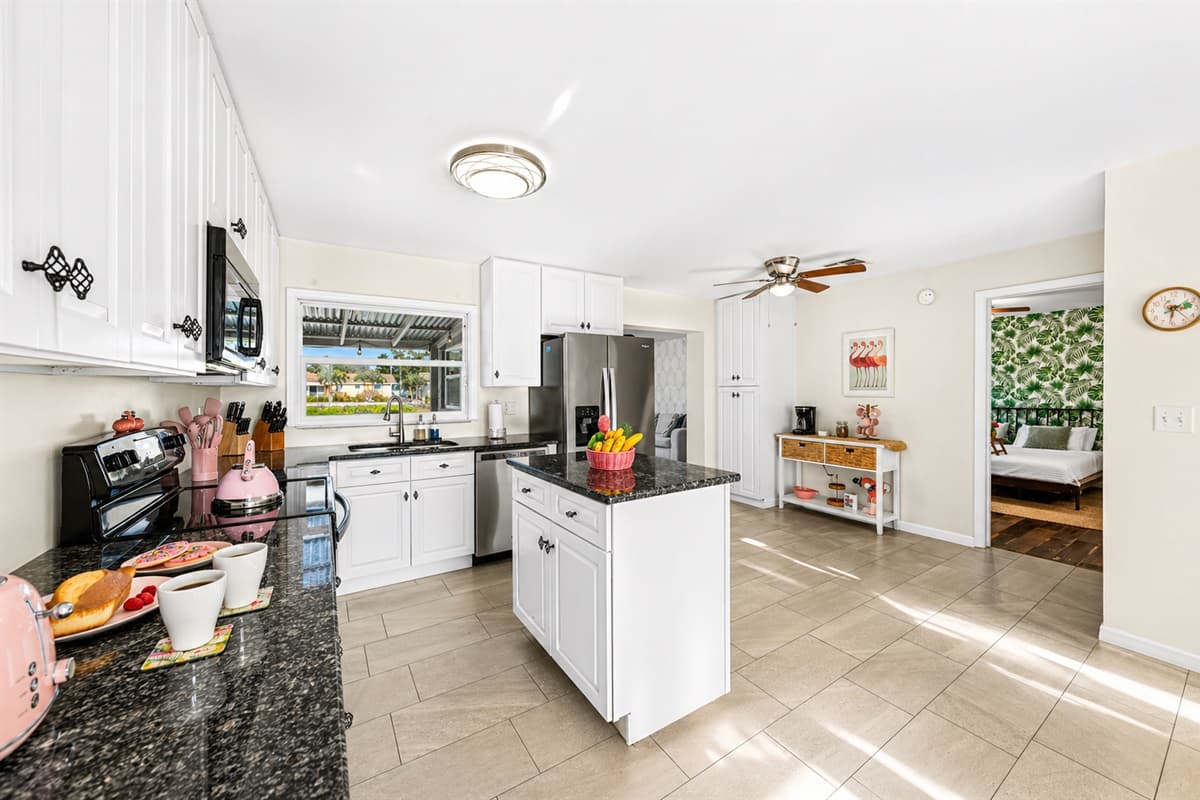 Wide-angle view highlighting the kitchen’s spacious design and natural light.