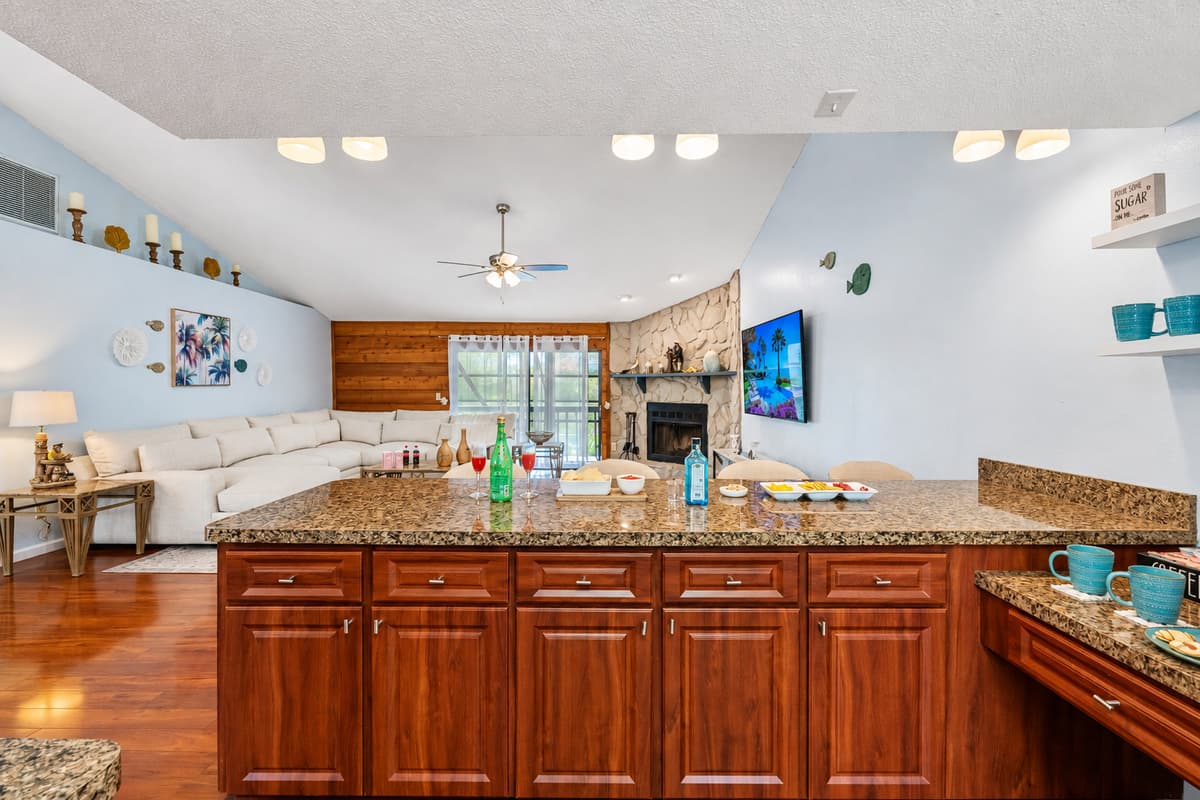 The kitchen is lined with deep cherry wood cabinets that provide a sense of warmth and elegance.