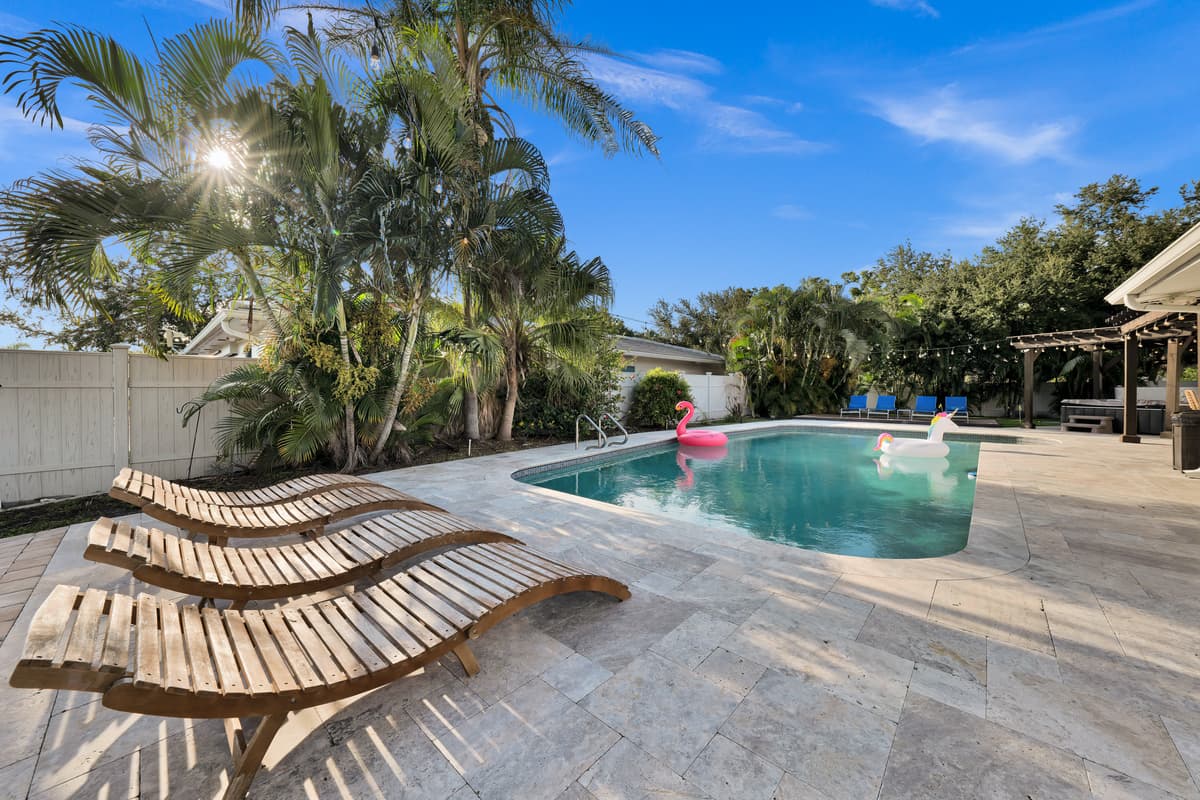 A flamingo float drifts across the pool while loungers sit ready poolside, an easy scene to picture yourself in