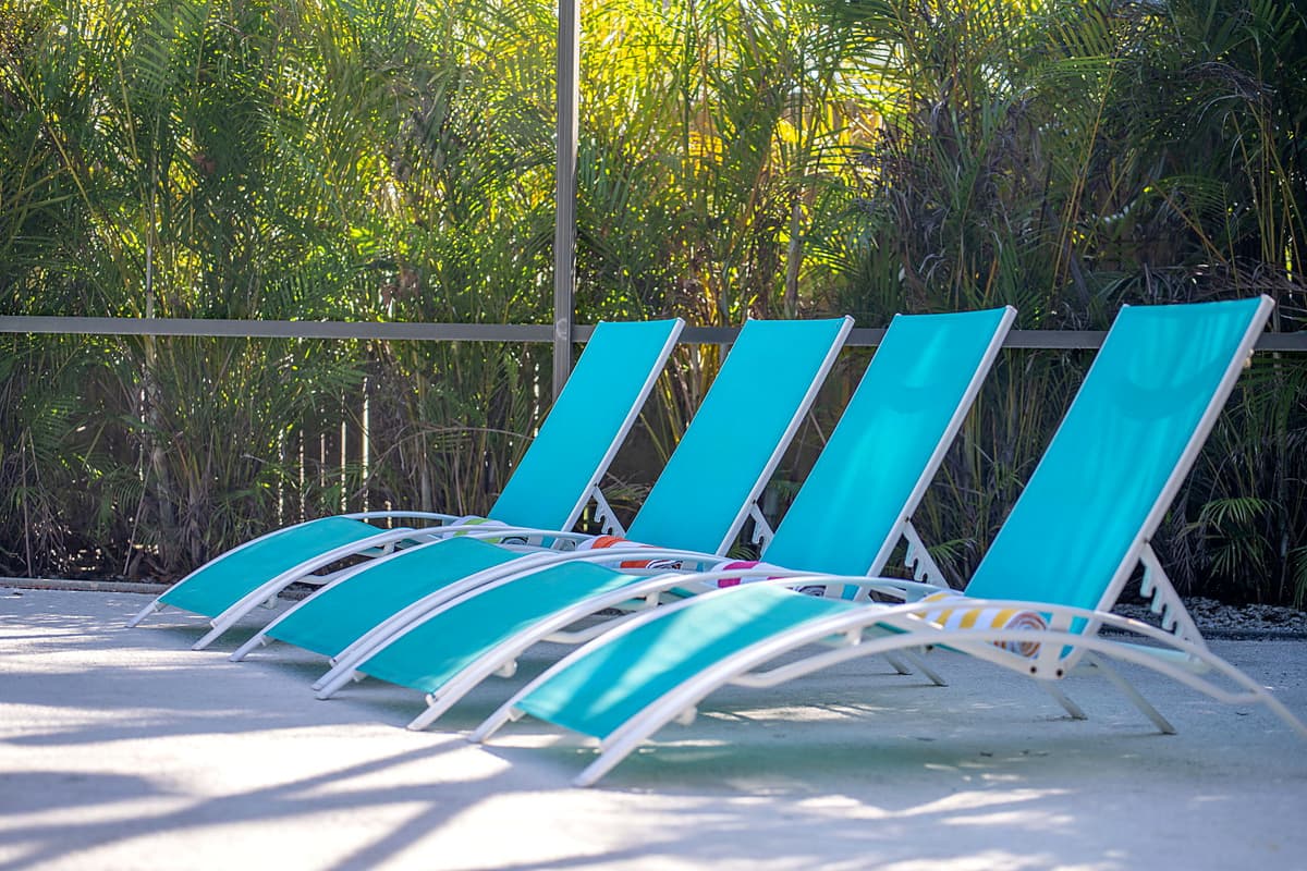 Surrounding the pool, you'll find comfortable lounge chairs strategically placed to provide the best spots for sunbathing.