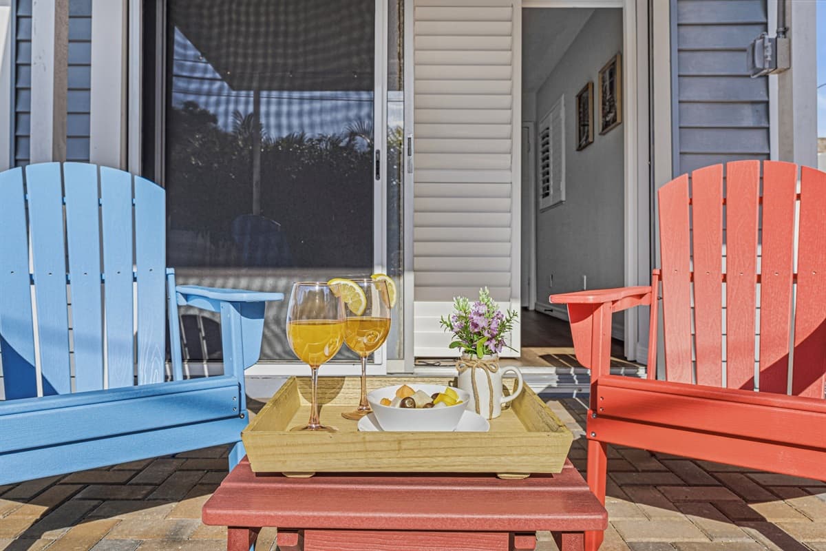 Close-up of outdoor seating with decorative setup—perfect for enjoying drinks and conversation 
Food and drinks shown are for staging purposes only and are not included.