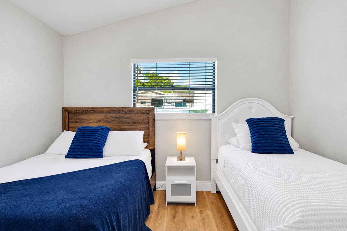 Two beds in one room means the kids stay together and the adults get their own space back. A full and a twin, a large closet and a ceiling fan — the sibling arrangement that solves itself in about four seconds flat.