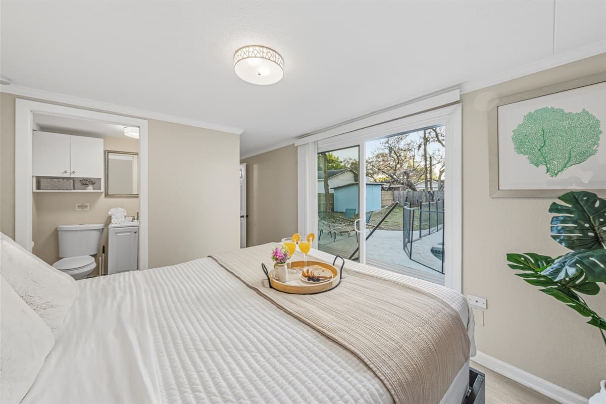 Master suite featuring backyard views and convenient access to the ensuite bathroom.