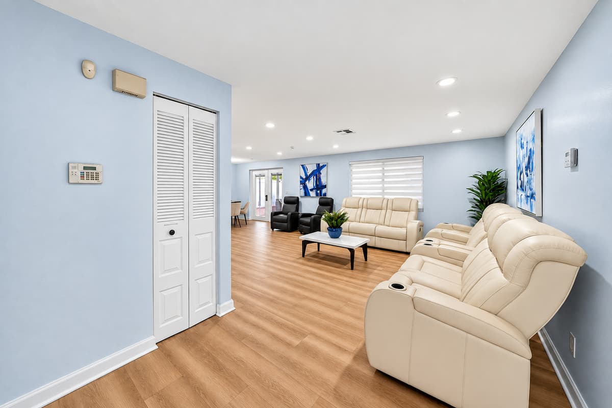 Bright and airy living space with an open layout that seamlessly connects the living room, dining area, and kitchen.